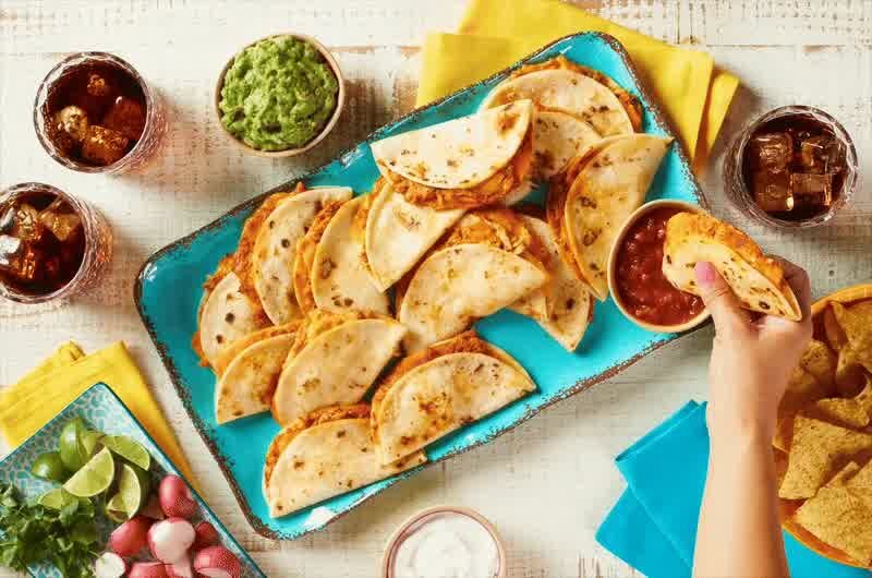 A hand grabbing a Don Lee Farms quesadilla