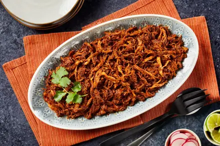 Slow-cooked shredded meat on a platter